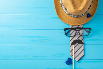 Get ready for a Father's Day celebration! Top-view shot featuring stylish fedora, classy tie,...