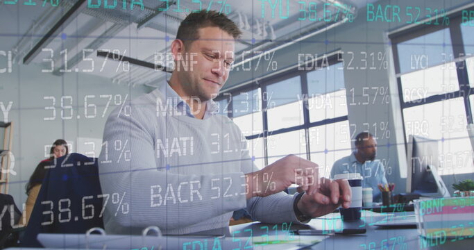 Image of trading board over smiling caucasian businessman using smartphone in office