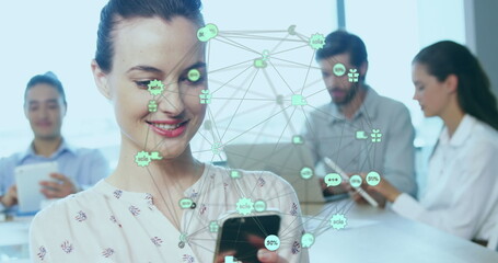 Image of globe of connections with icons over businesswoman using smartphone