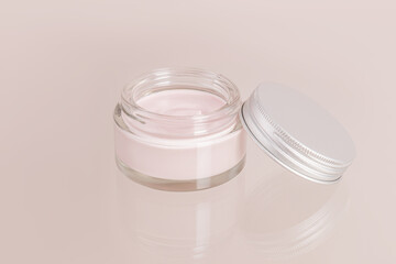 open cosmetic glass jar with cream for everyday self-care on a beige background and a glass surface. Front view. a copy space.