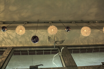 Decorative lamps hanging on the ceiling with the shadow on the wall. Interiors decoration.
