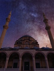 a building with a sky that has stars and a mosque in the background.