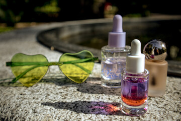 Tropical summer cosmetics. Cosmetic serum, oil extracts against lush greenery of tropics. Skin care...