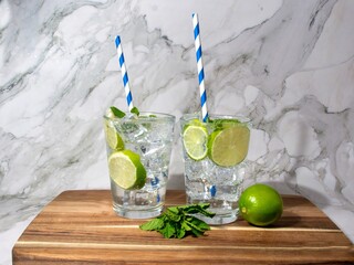 Healthy, easy virgin mojito mocktail with soda water garnished with more mint and lime wedges.