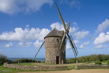 Plouezec, France - Apr 9, 2024: Wonderful landscapes in France, Brittany. De Craca windmill in Plouezec. Sunny spring day. Selective focus.