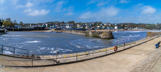 A panorama view from the outer harbour wall towards the village of Saundersfoot, Wales on a bright...