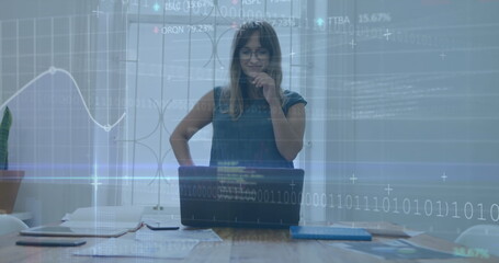 Image of financial data processing over businesswoman using computer