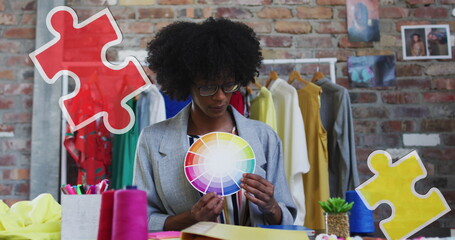 Image of puzzle pieces over african american female designer