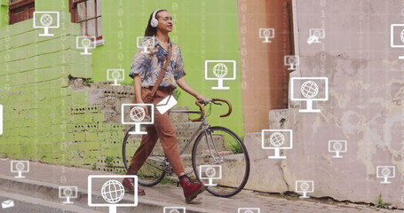 Image of network of screen icons with globes over biracial man with bike