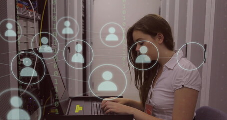Image of network of icons over caucasian businesswoman in server room using computer