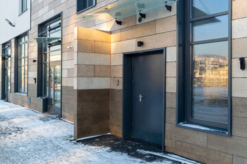 A building with a black door and a window on the side
