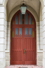 tall vintage brown wooden door with classic archway.