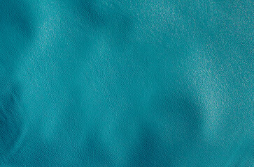 blue vinyl plastic rough textured background with wavy surface. elastic, smooth and shiny material