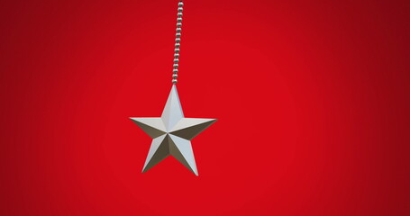 Image of hanging star swinging against red background