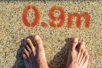 two feet at the pool entrance with a depth indication of 0.9 meters.