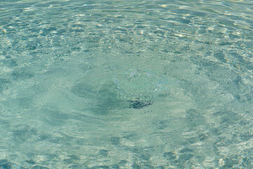 Colorless pool water with water pressure from the bottom and visible on the surface