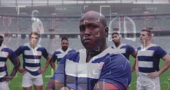 Image of human body data and statistics over multi-ethnic male rugby team standing on a pitch