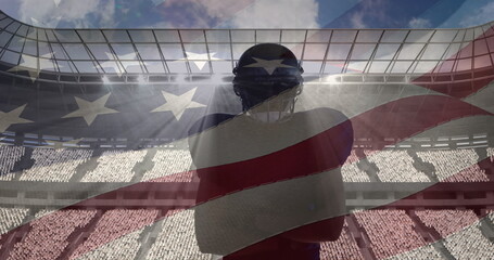 Composite image of american flag over male rugby player against sports stadium