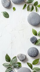 spa therapy stones and green leaves on white for peaceful meditation