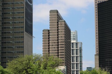 A high rise with two new additions of new glass towers each in a separate block.