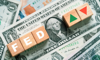 FED wording with green up and red down arrow on USD one dollar banknote for Federal bank reserve increase and decrease interest rate control which effect to America and world economic growth concept.
