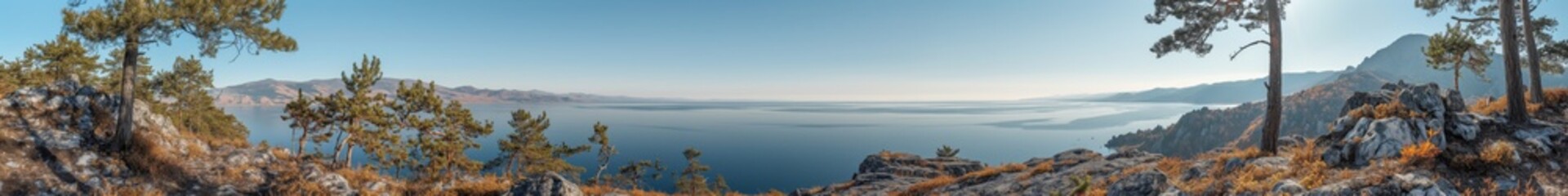 Fototapeta premium A blue river with steep, steep banks flows under a clear blue sky; bright flowers and a spreading tree create a picturesque landscape 