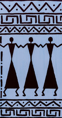 African drawing on a white wall with ornaments and figures of people, closeup - 785509493