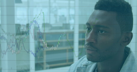 Image of financial data over african american designer using computer in office
