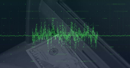 Image of financial data processing over banknote on desk