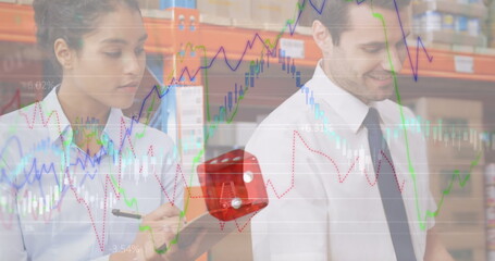 Image of financial graphs over diverse female and male warehouse workers making notes
