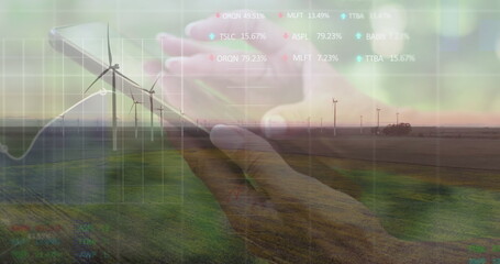 Image of financial data processing over caucasian woman using smartphone and wind turbine