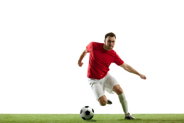 Dynamic image of young man, soccer player in motion with ball, running, training isolated on white...