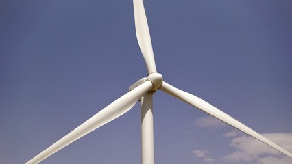 wind turbine blades against blue sky