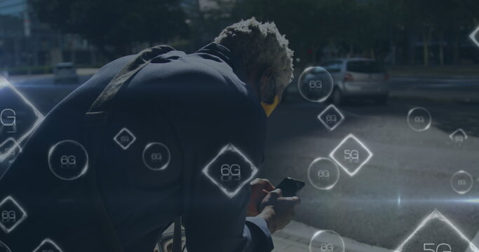 Image of graphical 5g and 6g text over african american man with mask using smartphone in city