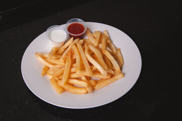 French fries with different toppings served on a white plate.