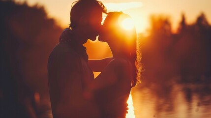 Silhouette of couple kissing under the warm glow of sunset, expressing love
