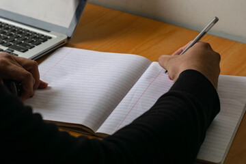 male hand writing, Male hand writing with pen on a lined notebook