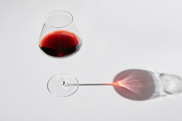 Red wine is in wineglass isolated on white background.