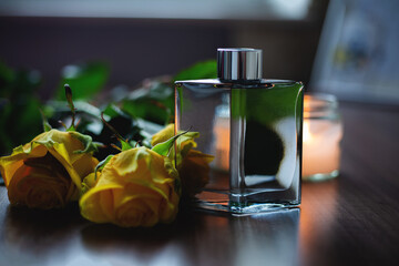 bottle of perfume and yellow flowers