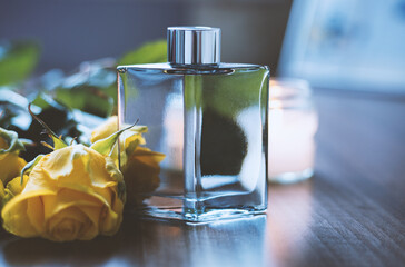 perfume with flowers on wooden table
