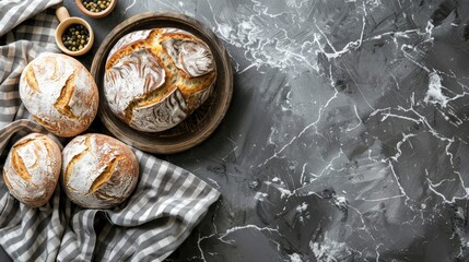   A collection of loaves of bread situated on a table, with a bowl of raisins nearby - obrazy, fototapety, plakaty