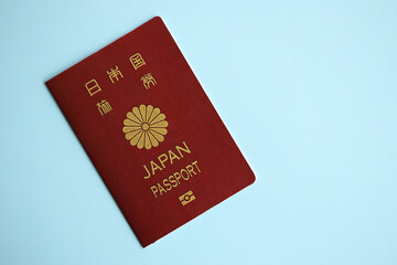 Japan passport on blue background close up. Tourism and citizenship concept