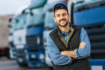 Happy confident male driver standing in front of his truck.