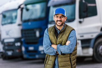 Happy confident male driver standing in front of his truck.