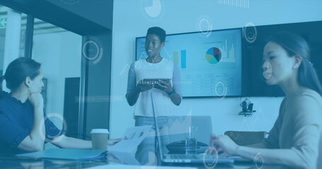 Image of data processing over african american woman giving a presentation at office