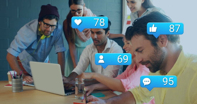 Image of message icons with changing numbers over diverse coworkers discussing report on laptop