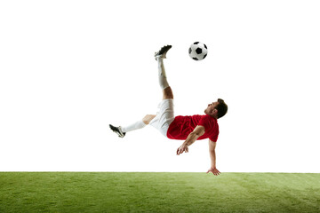 Young man, soccer player in motions during game, training, hitting ball and falling down isolated...