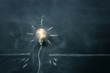 Education concept image. Creative idea and innovation. light bulb metaphor over blackboard background - 785538889