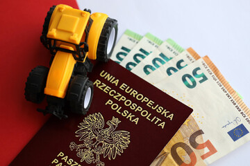 Red polish passport and yellow tractor on euro money and smooth red and white flag of Poland close...