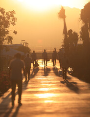 walking working people at orange sunset